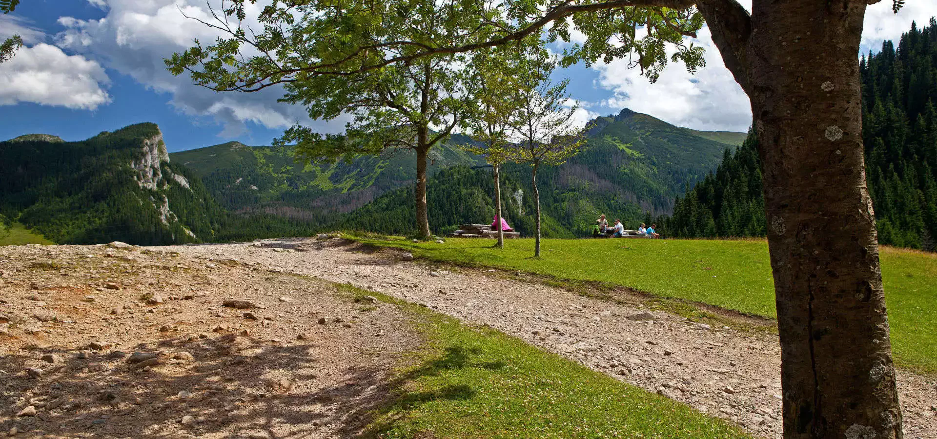 A spring trail and the green slopes of the Tatra Mountains during the May Bank Holiday